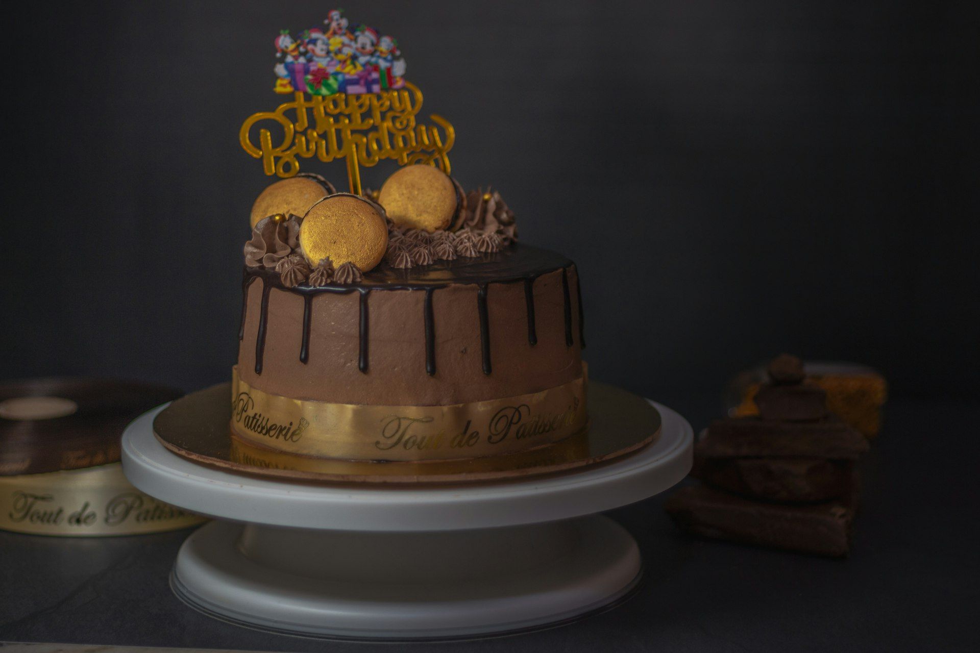 Celebration cake, cupcakes and small chops on a plum backdrop